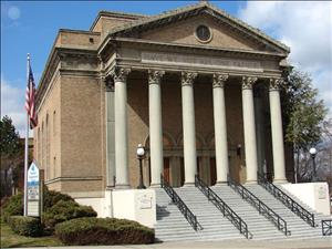 Plymouth Congregational Church, former Jewish Reform Temple Emanu-El, purchased by Congregational church in 1966 or 1967. shows a building of  Roman classical design. A broad set of stairs lead to the portico, where six Corinthian columns are topped by a stone or marble architrave carrying and an inscription in stone: “Have We Not All One Father,”  above that, just below the peaked roof, is etched a Star of David. 